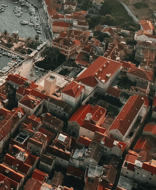 Aerial view of densely packed old town rooftops above a marina
